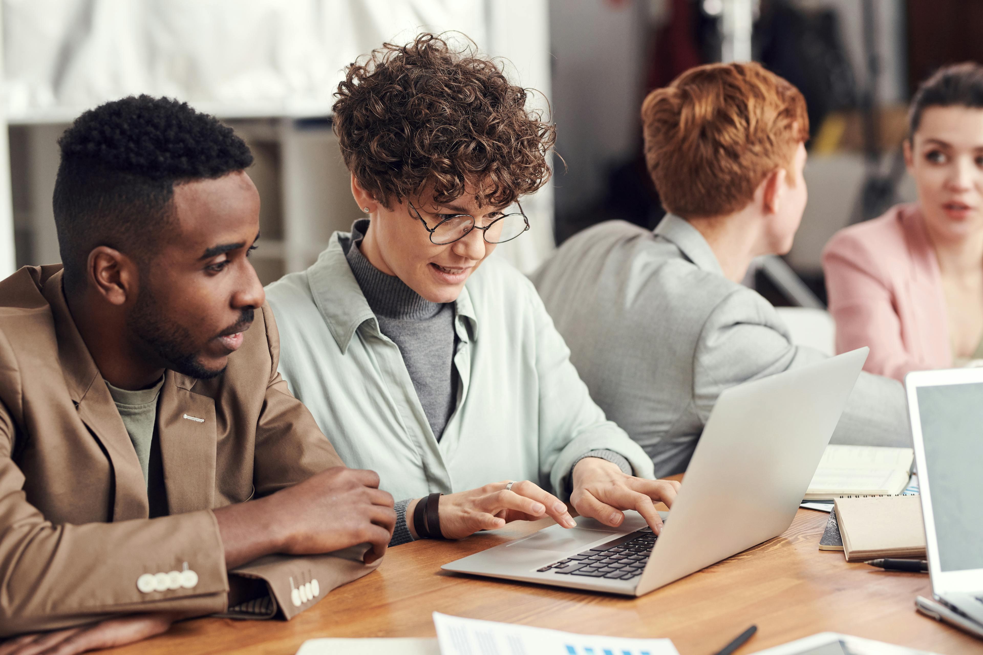 Team collaborating around a laptop during a growth meeting